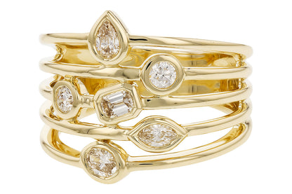 The Fancy Cut Diamonds Ring by Allison Kaufman showcases five stacked 14K yellow gold bands, each set with a pear, round, emerald, marquise, or oval fancy-cut diamond.