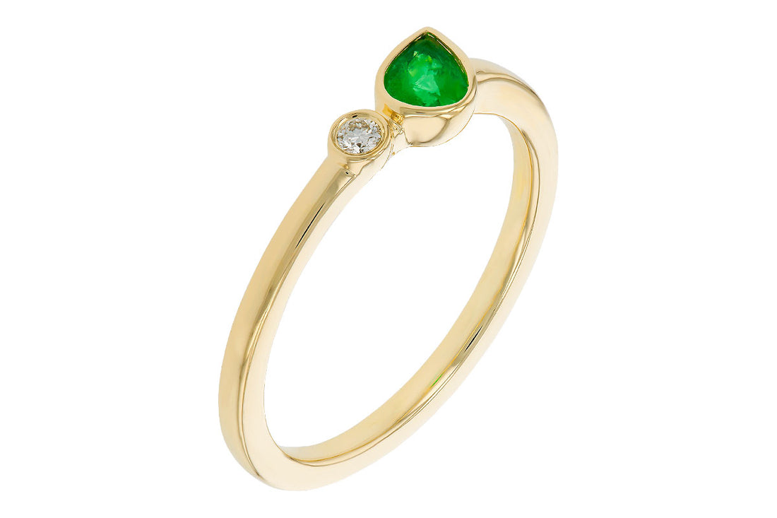 The Allison Kaufman 14k yellow .20ct emerald ring features a pear-shaped green gemstone paired with a small round white diamond on a slender band.