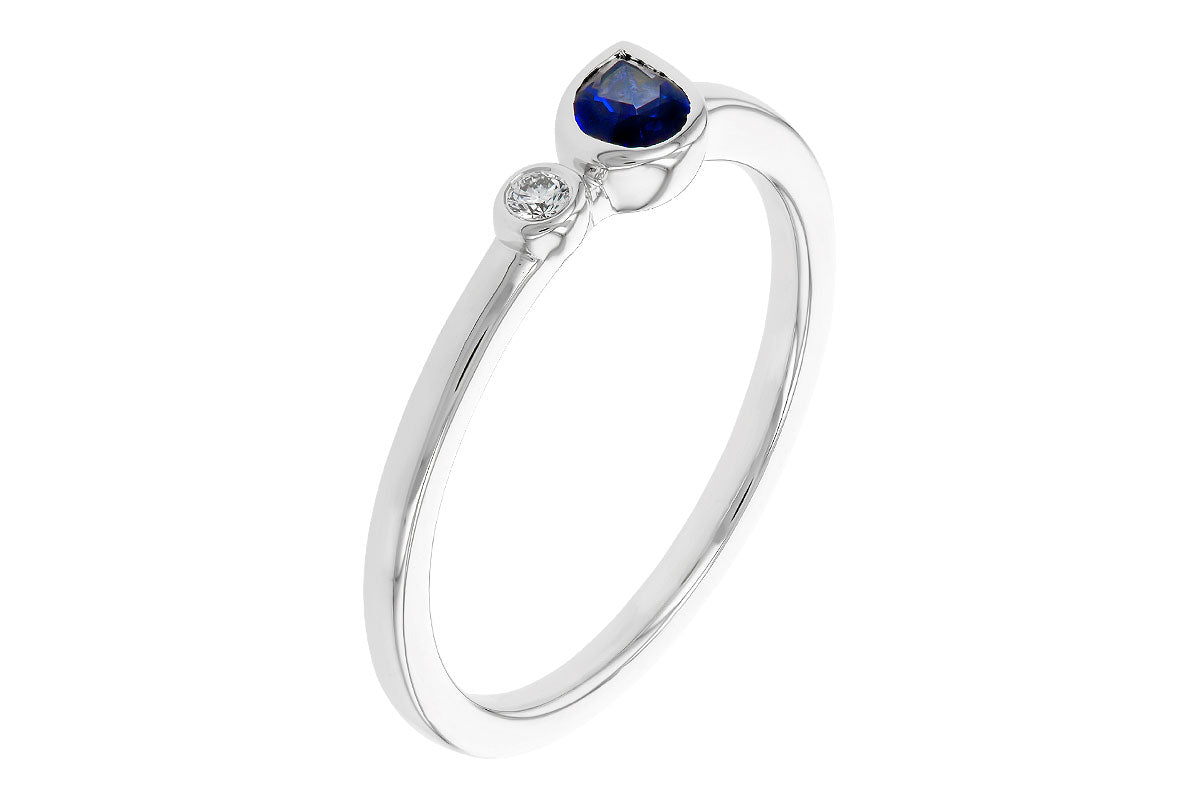 The Allison Kaufman 14k white .26ct sapphire ring features a round white diamond with a heart-shaped blue sapphire on a slender band.