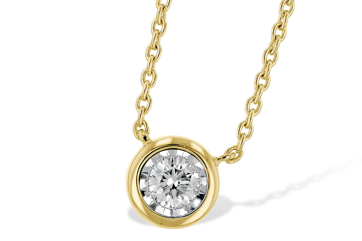 The Illusion Diamond Solitaire 14K Gold Necklace by Allison Kaufman features a round diamond in a smooth bezel set in 14K yellow gold, shining with classic elegance against a white background.