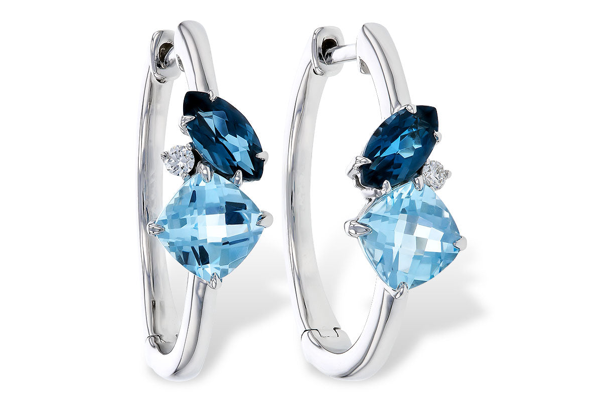 The Allison Kaufman 14K White Gold Blue Topaz and Diamond Hoop Earrings feature two blue topaz gems and a diamond on each hoop in a prong setting.