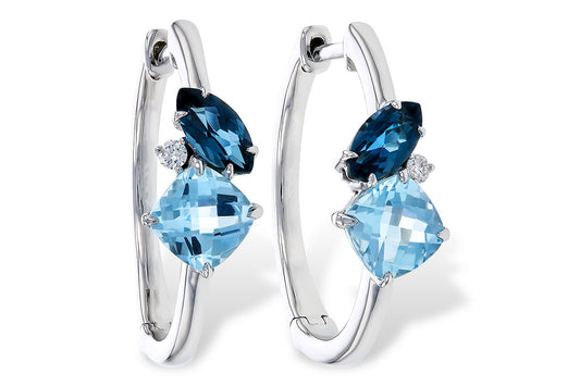 The Allison Kaufman 14K White Gold Blue Topaz and Diamond Hoop Earrings feature two blue topaz gems and a diamond on each hoop in a prong setting.