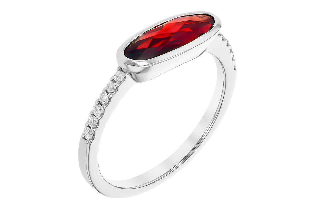 Introducing the Allison Kaufman Garnet and Diamond 14k White Gold Ring: This exquisite piece features an oval red garnet securely placed in a bezel setting. The band, crafted from 14k white gold, is beautifully accented with small clear diamonds on either side of the central gemstone, enhancing its sparkling allure. Photographed against a pristine white background, this ring is a true statement of elegance.