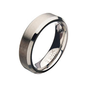 A close-up view of the Men's Stainless Steel 6mm Matte Beveled Band Ring by INOX in Size 11 reveals a brushed finish on the outer surface and polished, reflective edges. The inner side of the ring is smooth and polished, with text engraved on it.