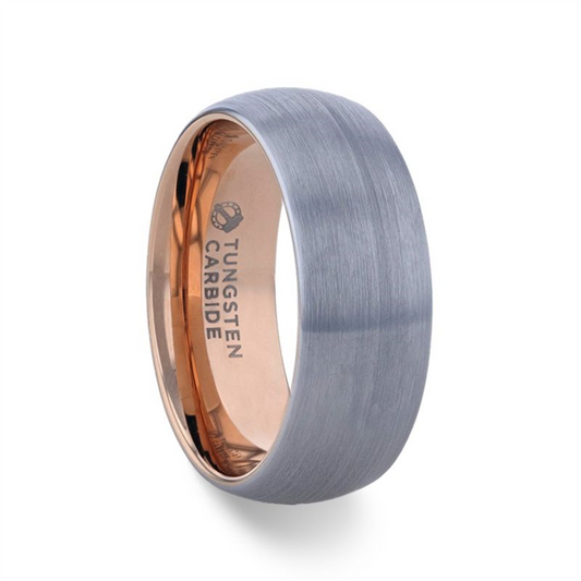 Image of the CAMERON Domed Brushed Finish Tungsten Carbide Men's Wedding Band with an 8mm brushed gray exterior and a polished rose gold interior. The interior features an engraved label that reads "TUNGSTEN CARBIDE." This Thorsten ring boasts a smooth, modern design with a slightly curved band, enhanced by rose gold ion plating.