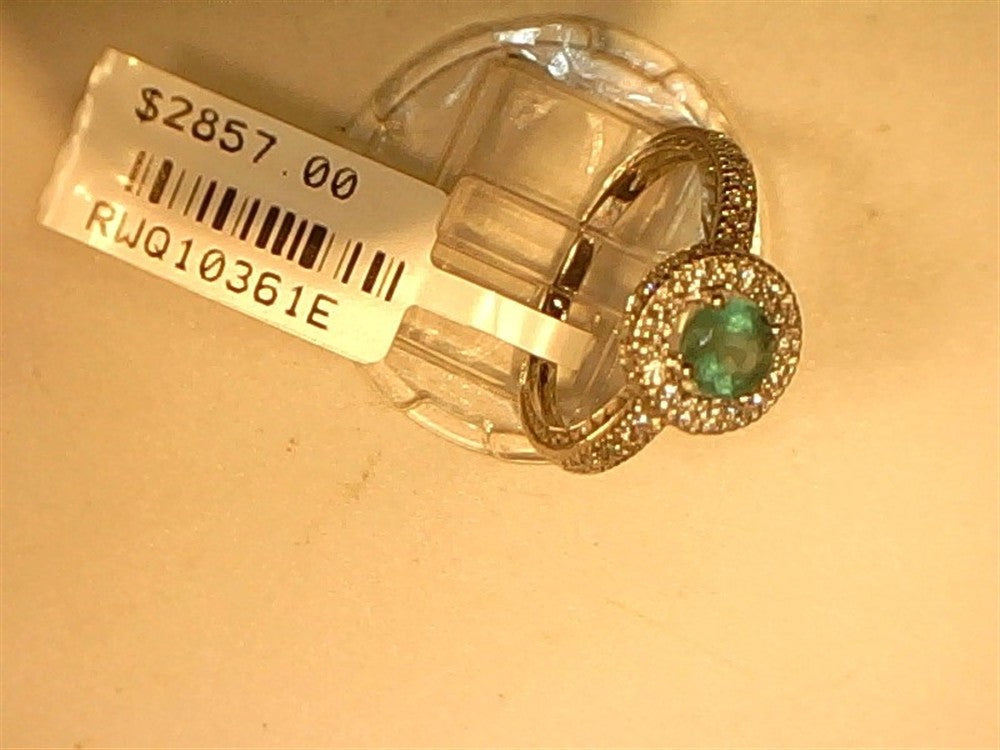 A Ryan Gems Diamond ring with round Emerald center, 14k white gold, size 6.75, code RWQ10361E is shown against a plain background with a $2857.00 price tag and small clear stones surrounding the emerald.