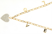 The 14k gold diamond heart LOVE necklace by Royal Jewelry features a heart-shaped pendant adorned with small diamonds totaling 0.34 carats, elegantly accentuated by a chain displaying dangling gold letters "L," "O," "V," and "E.