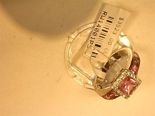 The Ryan Gems Diamond and Pink Sapphire Channel Set Ring features sparkling diamonds and pink sapphires in 14k white gold, size 6.5, displayed on a clear stand with a white price tag attached.
