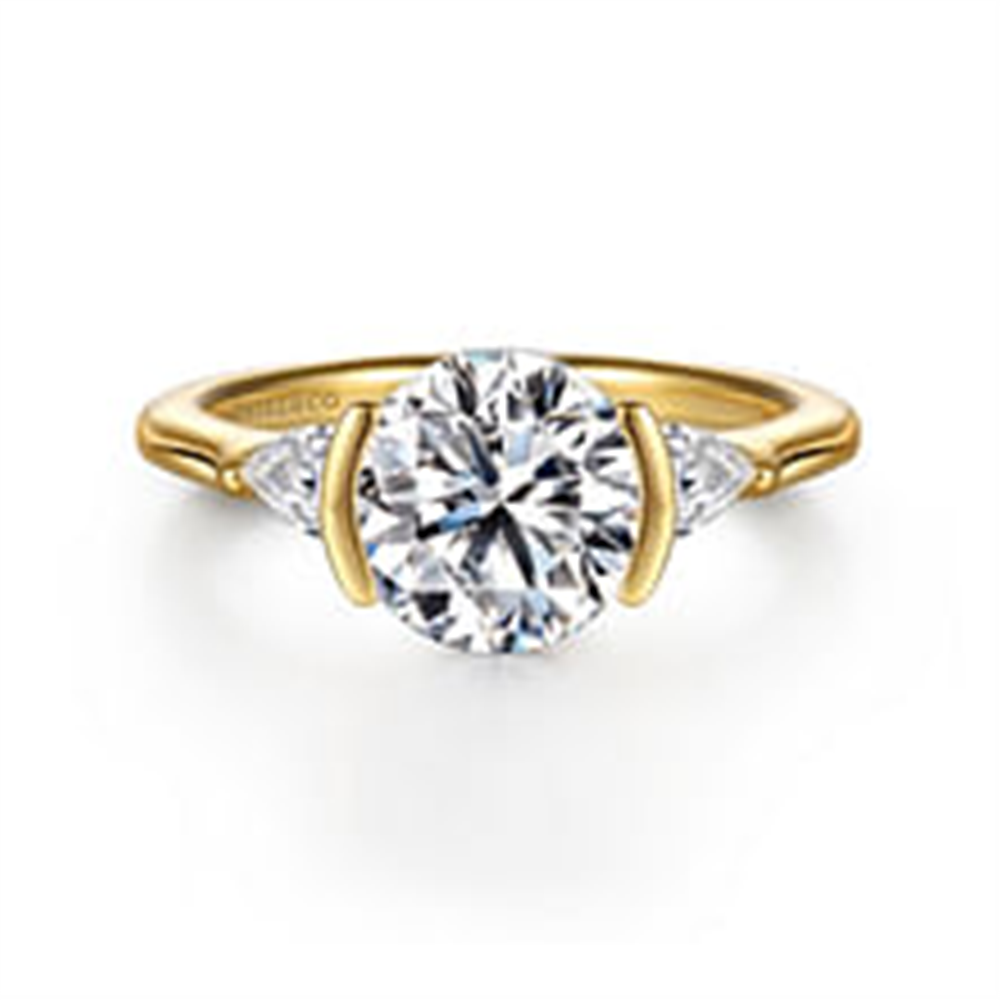 The Gabriel & Co 14K Yellow Gold Half Bezel Round Three Stone Diamond Engagement Ring features a large center diamond and two side stones, beautifully displayed on a white background.