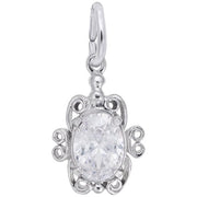This sterling silver Filigree April Birthstone Charm by Rembrandt Charms is a decorative pendant shaped like a turtle, featuring an ornate design with curving details. The centerpiece is an oval-cut, clear gemstone resembling a diamond, encased in the turtle's body. It includes a small loop for attaching to a chain.