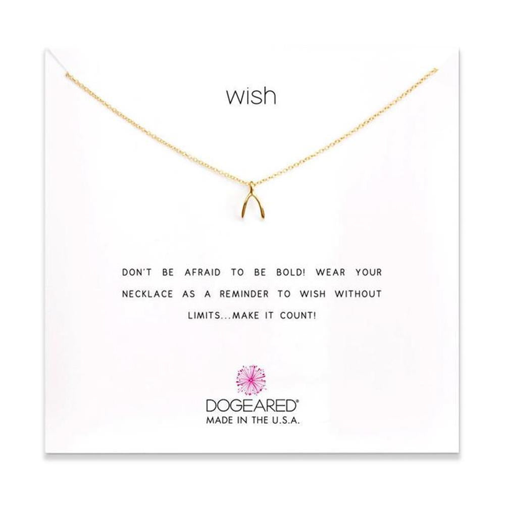 A delicate gold-plated sterling silver chain necklace with a petite wishbone charm, displayed on a white card. The card features "WISH" at the top and the inspiring message "DON'T BE AFRAID TO BE BOLD! WEAR YOUR NECKLACE AS A REMINDER TO WISH WITHOUT LIMITS... MAKE IT COUNT!" This timeless piece from Dogeared is ideal for those who believe in boundless possibilities. Product name: Wish/ GP-SS.

