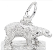 The Polar Bear Charm from Rembrandt Charms is crafted in sterling silver and depicts a polar bear standing on a textured surface. This charming piece features a small loop on its back for easy attachment to a chain or necklace. The detailed design beautifully highlights the bear's fur and form.