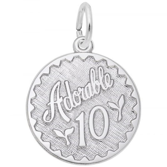 The "Adorable 10 Charm" by Rembrandt Charms is a round, Sterling Silver pendant with the words "Adorable Ten" engraved at the top and the number "10" below it. It features two small leaf-like designs and a textured background, complete with a small loop at the top for easy addition to a necklace or bracelet.