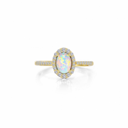 The Lafonn RG CL/SIMULATED OPAL S.S. GP 1.92 CTW OPAL HALO RG #7 is a stunning gold halo ring featuring an oval-shaped opal as the central gemstone, surrounded by a halo of small diamonds and adorned with additional diamonds on the band. The opal showcases a range of pastel colors, including pink, blue, and green.
