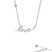 The Love Word Necklace by Lafonn is a delicate sterling silver piece with the word "love" elegantly spelled out in cursive script. Two Lassaire simulated diamonds are embedded on the chain, one on each side of the word. This necklace, bonded with platinum, features a simple clasp closure at the back.