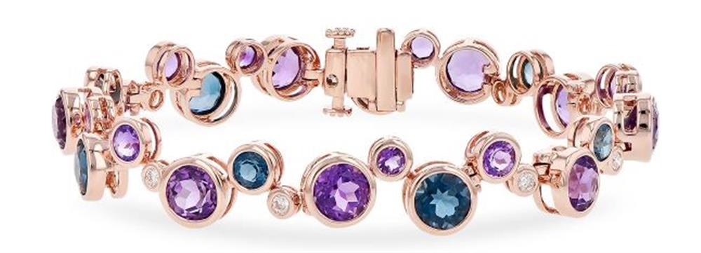 The "Semi-Precious and Diamond 14k Rose Gold Bracelet" by Allison Kaufman is a rose gold accessory embellished with gleaming semi-precious gemstones in hues of purple, blue, and clear. It includes a clasp fastening and sophisticated, intricate settings for each gemstone.