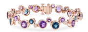The "Semi-Precious and Diamond 14k Rose Gold Bracelet" by Allison Kaufman is a rose gold accessory embellished with gleaming semi-precious gemstones in hues of purple, blue, and clear. It includes a clasp fastening and sophisticated, intricate settings for each gemstone.