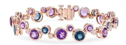 The "Semi-Precious and Diamond 14k Rose Gold Bracelet" by Allison Kaufman is a rose gold accessory embellished with gleaming semi-precious gemstones in hues of purple, blue, and clear. It includes a clasp fastening and sophisticated, intricate settings for each gemstone.