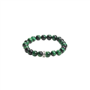 The King Baby bracelet features 10mm green tiger eye and black beads with a metallic charm engraved with a logo ring at the center, all polished and evenly spaced on an elastic band against a plain white background.