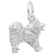 The Rembrandt Charms Chow Chow Dog Charm in Sterling Silver is a detailed piece designed as a fluffy dog with a curly tail, standing on all fours. It features a small loop on top for attaching to a bracelet or necklace, with the fur textured to give the dog a realistic appearance.
