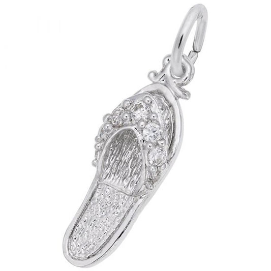 A close-up of the Rembrandt Charms "Sandal with CZ Charm" sterling silver pendant showcases intricate detailing, including bead-like patterns on the upper part. The pendant features a small loop at the top for attaching to a necklace or bracelet.