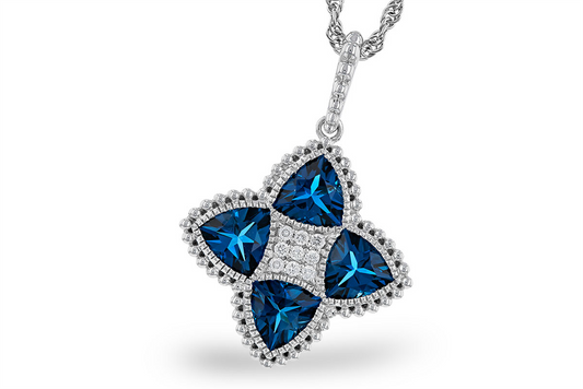 The Allison Kaufman Trillion cut LBT and diamond 14k white pendant features a four-petal flower design with dark blue triangle stones, a diamond cluster center, and a beaded silver border.