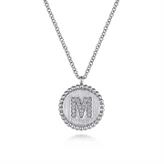 Presenting the Gabriel & Co. 925 Sterling Silver Diamond Bujukan Initial "M" Necklace. This exquisite piece features a round pendant adorned with small diamonds, gracefully hanging from a fine chain and bordered by a delicate scalloped edge of tiny diamonds. The intricate details of the jewelry are elegantly set against a plain white background to highlight its sophistication.