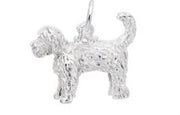 The Goldendoodle Dog Charm from Rembrandt Charms is crafted from sterling silver and intricately designed to capture the detailed fur texture of a Goldendoodle. This charm depicts the dog standing with its tail curved upward, exuding true canine cuteness. A small loop is attached to the dog's back, making it easy to add to a bracelet or necklace.