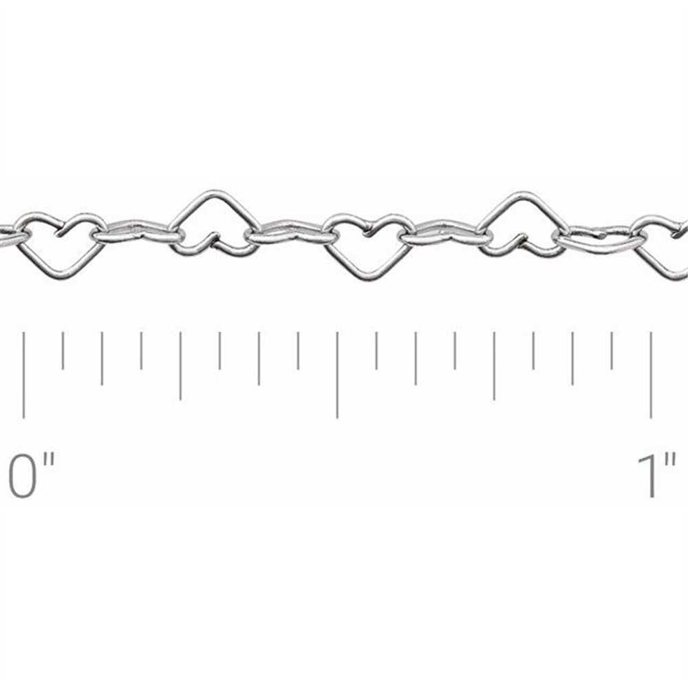 The Polished Heart Sterling Silver chain by Stuller-Stuller, featuring intricately shaped heart links each less than an inch wide, is showcased against a pristine white background, highlighting its delicate elegance.