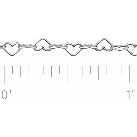 The Polished Heart Sterling Silver chain by Stuller-Stuller, featuring intricately shaped heart links each less than an inch wide, is showcased against a pristine white background, highlighting its delicate elegance.