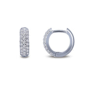 A pair of stunning 3-Row Huggie Hoop Earrings by Lafonn is shown. One earring is displayed from the front, highlighting its encrusted diamonds, while the other earring is shown from the side, partially open, revealing its clasp mechanism. The background is plain white.