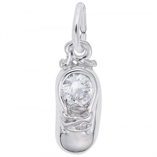 The April Baby Shoe Sterling Silver Charm by Rembrandt Charms is shaped like a baby shoe with detailed lace and features a large crystal buckle. It includes a small loop for easy attachment to bracelets or necklaces, making it an enchanting keepsake.