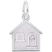 The Rembrandt Charms House Charm in sterling silver showcases intricate horizontal lines, a small rectangular window, and a door with a circular window. It features a loop on top for easy attachment to a bracelet or necklace.