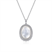 The Gabriel & Co 925 Sterling Silver Rock Crystal and White MOP Pendant Necklace features a delicate chain and an oval pendant with a faceted rock crystal, surrounded by a beaded silver border. The pendant's intricate design adds elegance, making it a standout piece from the Bujukan Collection.