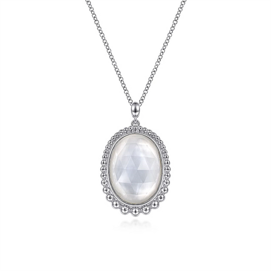The Gabriel & Co 925 Sterling Silver Rock Crystal and White MOP Pendant Necklace features a delicate chain and an oval pendant with a faceted rock crystal, surrounded by a beaded silver border. The pendant's intricate design adds elegance, making it a standout piece from the Bujukan Collection.