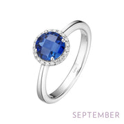 The Lafonn September Birthstone Ring Size 8 is a stunning silver ring featuring a large, round blue sapphire gemstone at its center, surrounded by a circle of smaller clear diamonds. The words "SEPTEMBER birthstone" are written in light purple at the bottom right corner.
