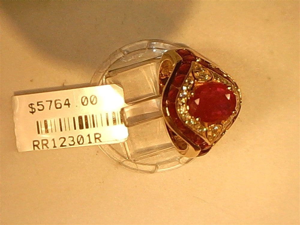 The Ryan Gems Diamond and Ruby (eye) ring in 14k rose gold, size 7, showcases a striking red gemstone surrounded by diamonds. Displayed on a clear stand, it's tagged "$5764.00" with code "RR12301R.