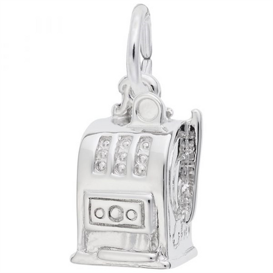 The Las Vegas Slot Machine Charm - SS by Rembrandt Charms is a silver-colored charm shaped like a slot machine, featuring intricate details such as reels, buttons, and a side handle. It includes a small loop at the top for easy attachment to a bracelet or necklace.