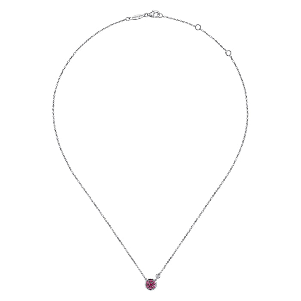 A delicate 925 Sterling Silver Ruby Cluster and Diamond Pendant Necklace, part of Gabriel & Co's Lusso Color Collection, showcases a small, circular pink gemstone pendant at its center. The necklace features a clasp closure and is displayed against a white background.