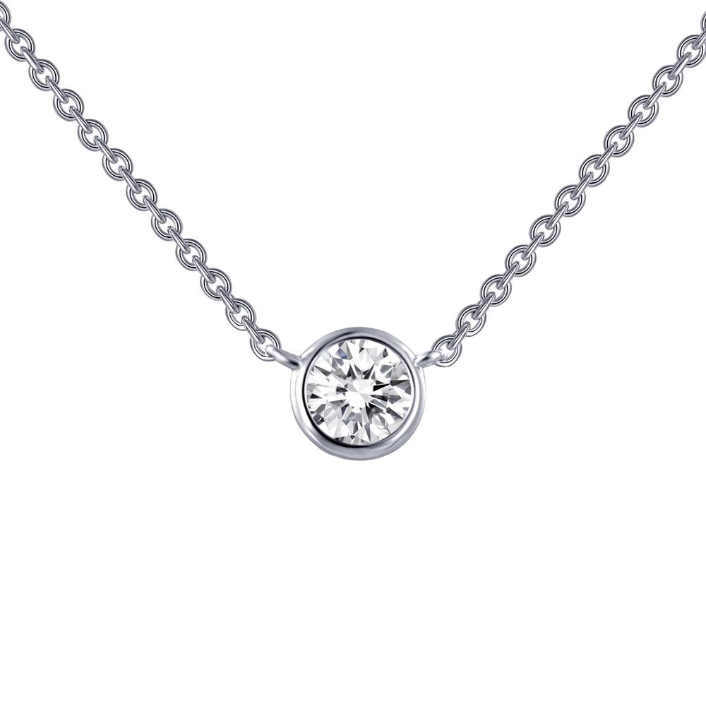 A close-up image of the 1/2 Carat Diamond Solitaire Necklace by Lafonn showcases a delicate sterling silver chain and a single round-cut simulated diamond pendant set in a simple bezel. The necklace boasts a minimalist and elegant design.