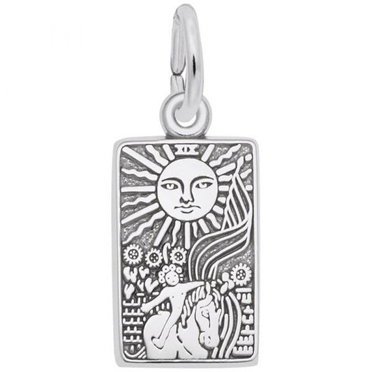The Tarot Card Charm by Rembrandt Charms is a rectangular sterling silver pendant engraved with a sun featuring a face at the top, emitting radiant rays downward. Below the sun, the intricate design includes flowers, a woman's head with flowing hair, and a detailed border that evokes the style of a tarot card. The charm comes with an attached loop for wearing.