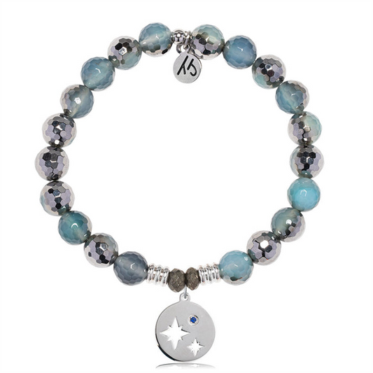 The T Jazelle Blue Silver Agate Gemstone Bracelet features alternating blue and silver beads, a sterling silver Mother Son charm with star and moon cutouts, a blue gemstone, and an engraved tag—perfect as a Mother Son bracelet.