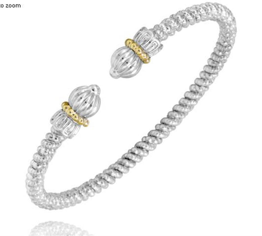 Discover the elegant Alwand Vahan Jewelry's 3MM Open Band /14KY and SS, a silver cuff bracelet featuring a spiraled texture. Each end is adorned with a detailed, bulbous silver design accented by gold-colored bands. The open-ended bracelet offers flexibility and showcases the beautiful craftsmanship of SS with 14KY accents.