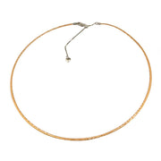 The Bellarri 14K Reversible Omega Chain features a blend of rose and white gold, a sleek minimalist design, and an adjustable length from 17" to 19". It's a chic option for those who appreciate both style and versatility in their jewelry collection.