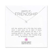 An 18-inch SS Necklace by Dogeared, featuring a single pearl pendant, sits on a card that reads: "Pearls of Friendship. With time, patience, and a little help from Mother Nature, a pearl grows into an object of beauty and simplicity. Pearls represent the best in us... Made in the U.S.A.