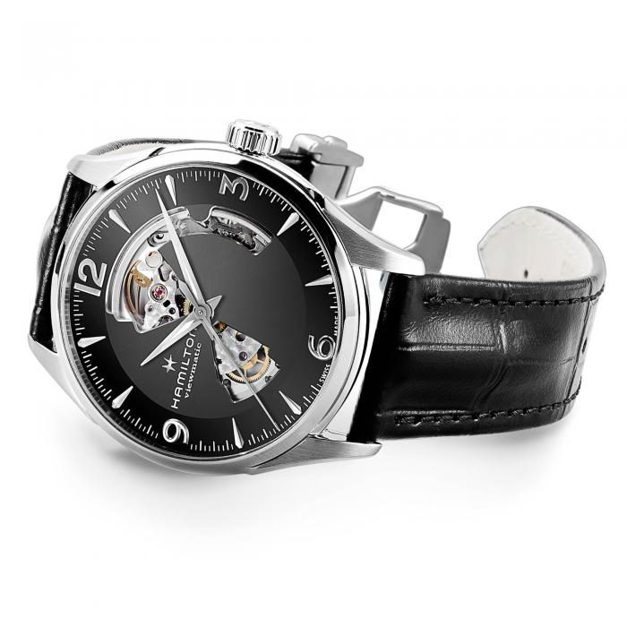 A sophisticated Jazzmaster Automatic Open Heart watch by Hamilton, featuring a black leather strap and silver detailing. The black watch face includes silver hour markers, an exposed gear mechanism, and the brand name "Hamilton Jazzmaster Open Heart." The Swiss automatic movement ensures precision, while the partially open design reveals the buckle.