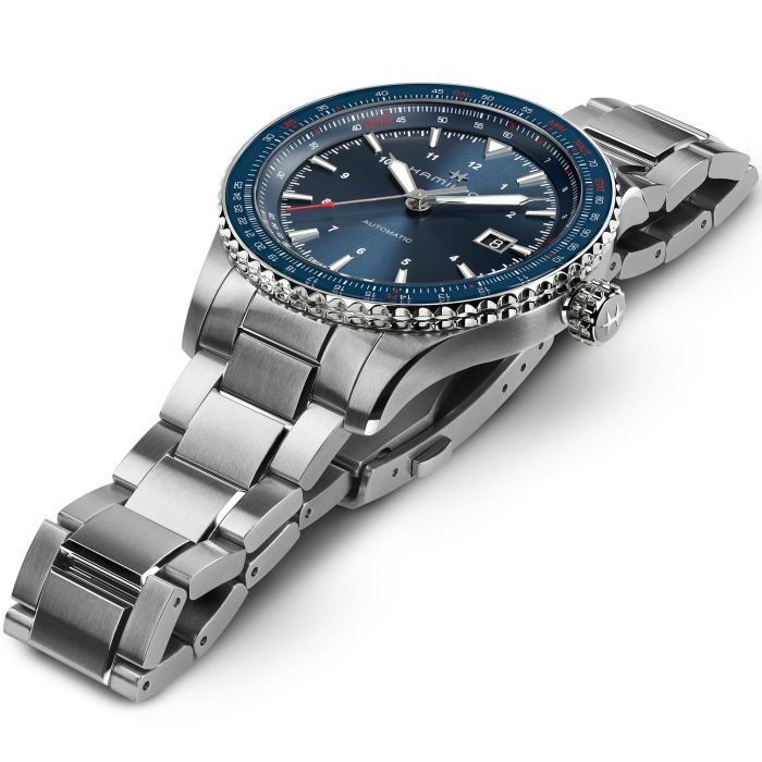 The Hamilton Khaki Aviation Automatic Watch offers a sophisticated stainless steel wristwatch design with a dark blue slide-rule bezel, a matching blue dial, and white hour markers. This timepiece also boasts an 80-hour power reserve and features a date display at the 3 o'clock position. A side view reveals the watch's polished metal finish and substantial clasp.