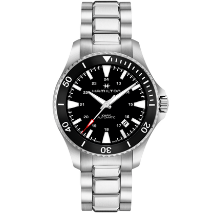 The Hamilton Khaki Navy Scuba Automatic Watch features a silver stainless steel band, a ceramic bezel, and a black dial with white hour markers. This timepiece displays both 12-hour and 24-hour formats, includes a date window at the 4 o’clock position, and boasts an impressive water resistance of up to 300 meters.