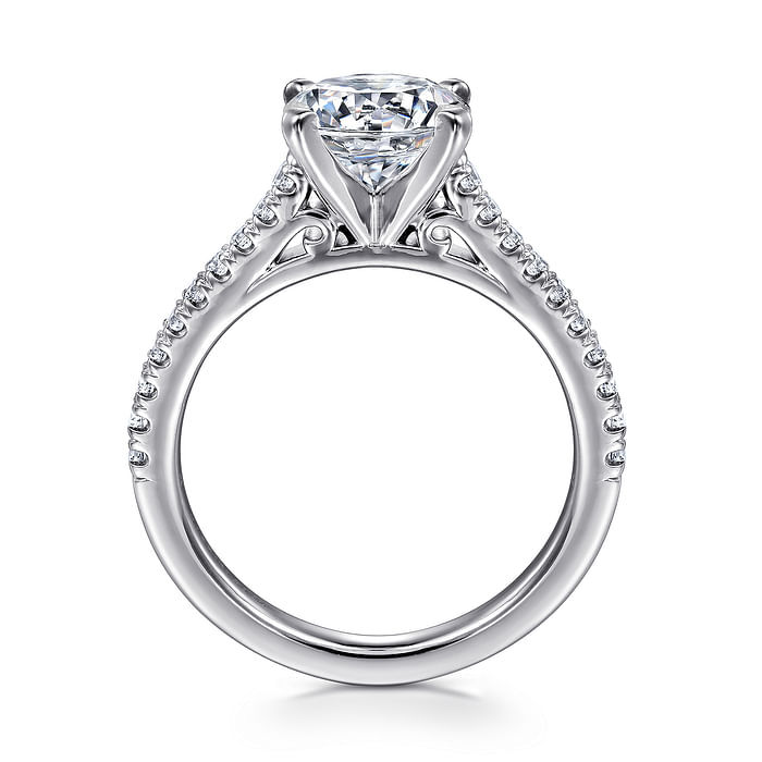 The Gabriel & Co 14K White Gold Round Diamond Engagement Ring | 1.50 carat showcases a large center diamond in four prongs, accented by small diamonds on the band and ornate scrollwork beneath the stone.