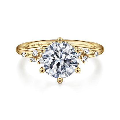 The Gabriel & Co 14K Y floral band engagement ring features a large round diamond center stone with smaller diamond accents in a delicate nature-inspired design.